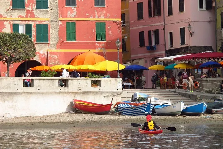 Kayakers paddling along the Cinque Terre coast on a guided trip from Monterosso