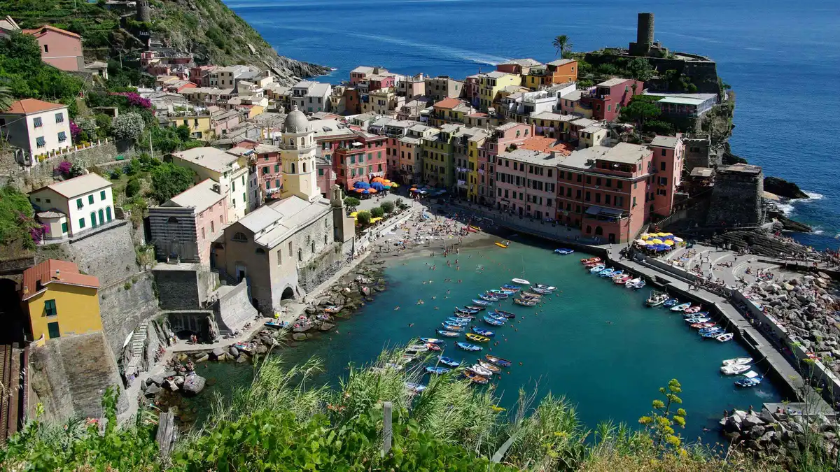 Tour group exploring a colorful Cinque Terre village on a day trip from Florence