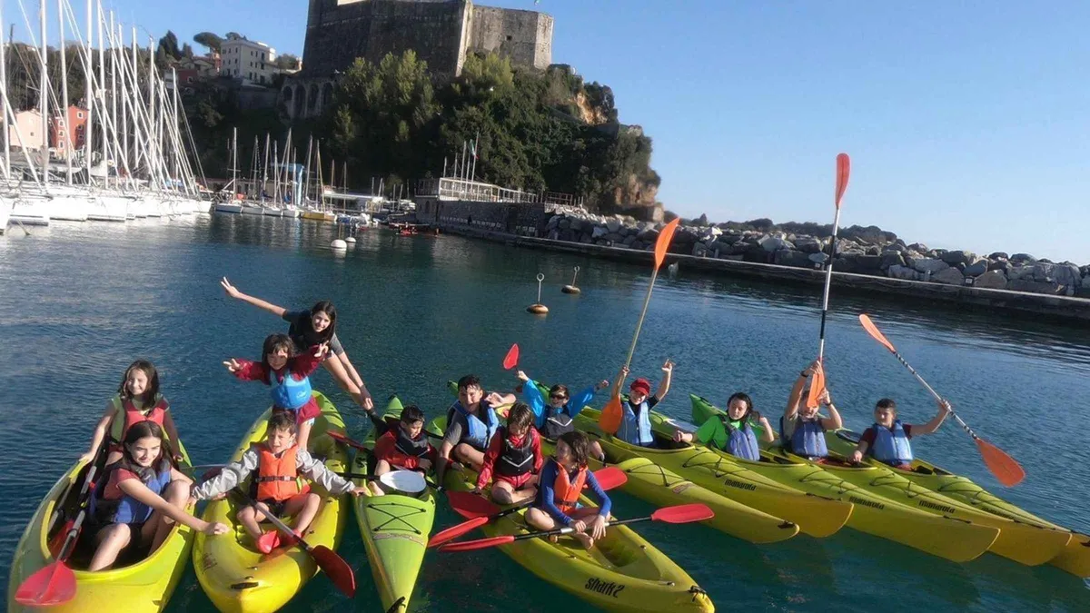 Kayakers paddling along the coast from Lerici to Tellaro in the Gulf of Poets