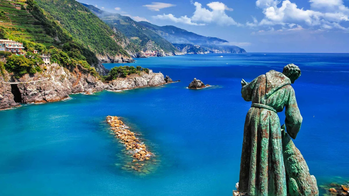 Ferry boat with tour guide sailing past the cliffside villages of the Cinque Terre from La Spezia