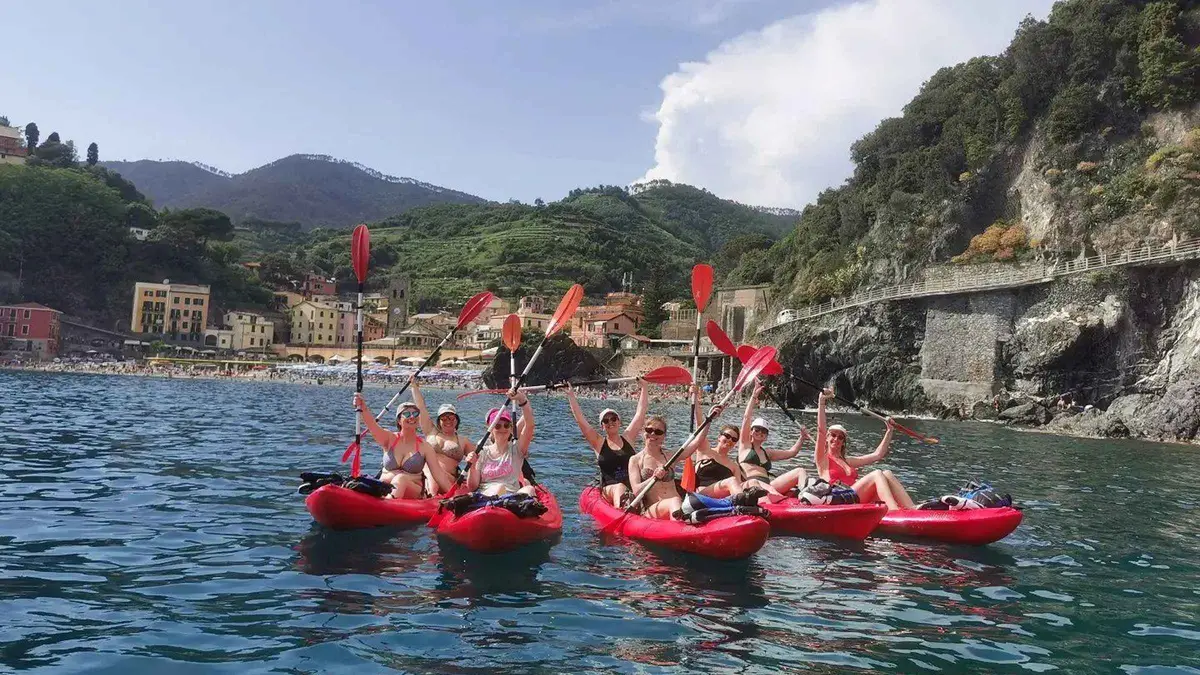 Sea kayaker snorkeling along the rocky Cinque Terre coastline near Monterosso