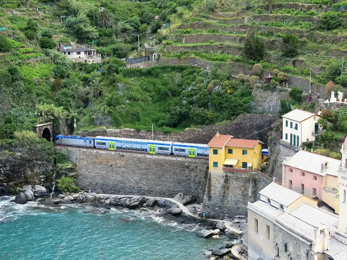 A Cinque Terre Express train leaving Vernazza station seen from the castle above, Cinque Terre, Italy