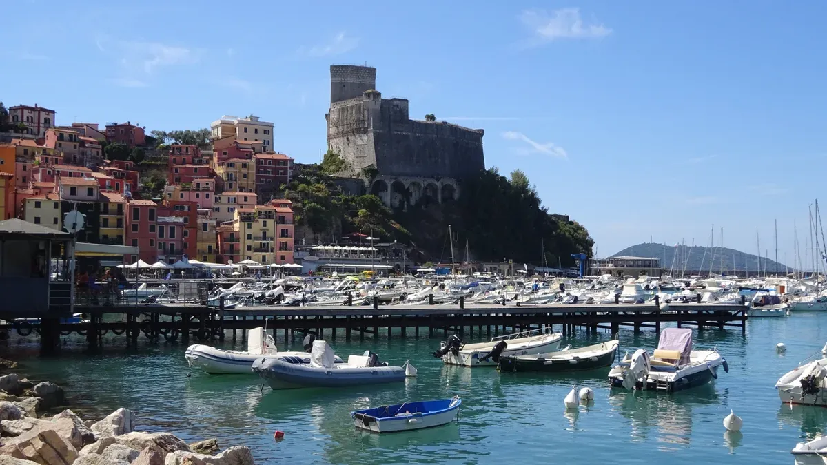Castello di Lerici on its headland above the colourful old town and marina, Italy