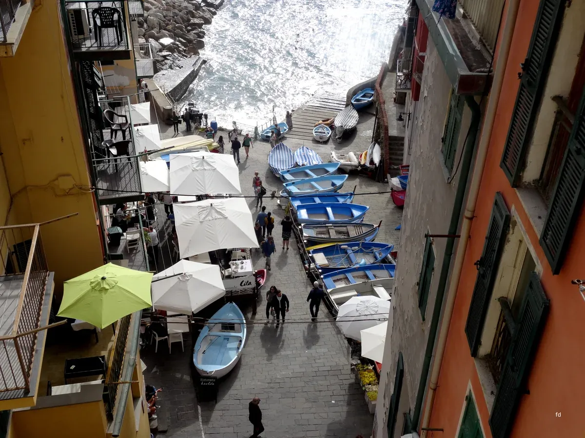 Riomaggiore, Cinque Terre, seen from the sea with tower houses rising above the harbour