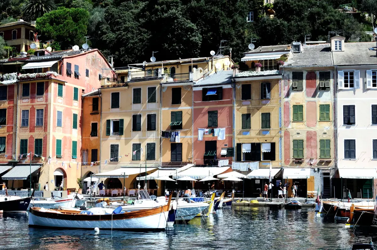 Colourful waterfront houses and moored boats in Portofino harbour on the Riviera di Levante, Italy